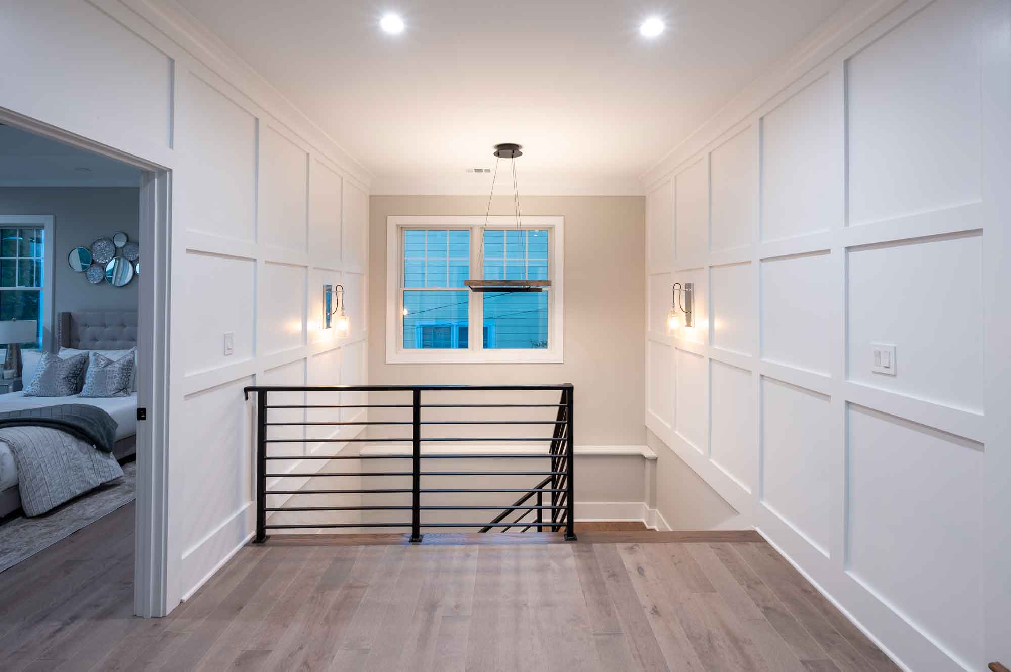 Whole home renovation featuring custom moulding, modern staircase and blonde hardwood floors